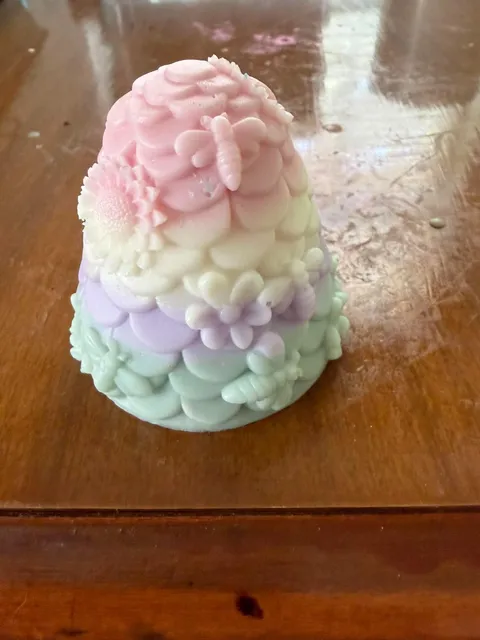 Handmade pastel beehive design with flowers and bees